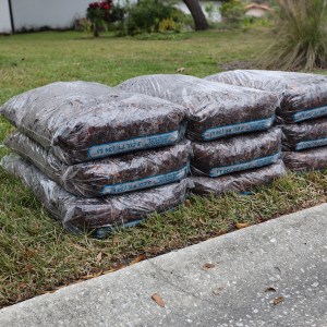 Pine bark mulch bags stacked in multiple layers for residential delivery