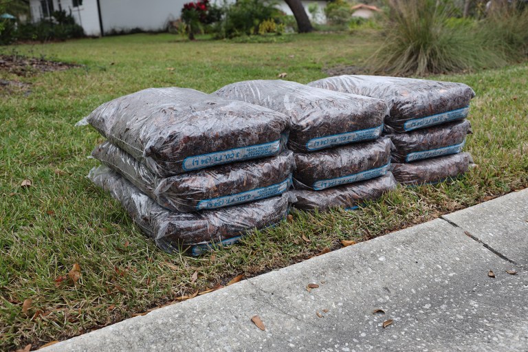 Pine bark mulch bags stacked in multiple layers for residential delivery